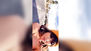 Riley Reid recording herself driving a toy car down a residential street in the middle of the day completely nude [gif]